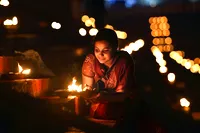 Woman lighting lamps